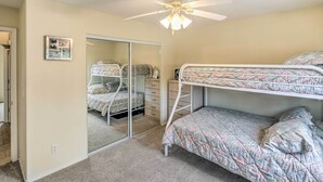 A bedroom with bunk beds, a ceiling fan, a mirror, and a clock on the wall. - Arizona Retreat w/ Casita ~ 2 Mi to Lake Havasu (Lake Havasu City)