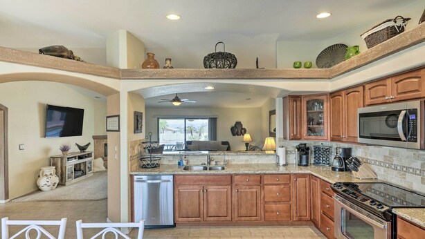 A spacious kitchen with wooden cabinets, a dishwasher, a stove, and a microwave. - Arizona Retreat w/ Casita ~ 2 Mi to Lake Havasu (Lake Havasu City)
