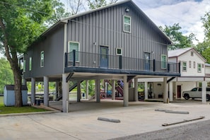 A two-story building with a balcony, a covered area, and a parking lot. - Outdoor Entertainment Space: Home in Mcqueeney (McQueeney)