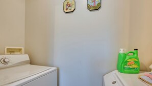 A laundry area with a washing machine, a dryer, and a bottle of Gain detergent. - Spacious Wellston Home Near Hiking & Skiing! (Wellston)