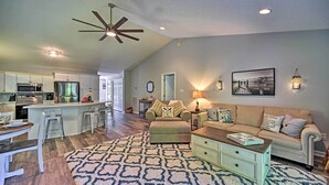 A spacious living area with a kitchen, a dining table, and a sofa.