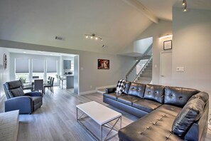 Relax in this spacious living room with a sofa, recliner, and dining area.