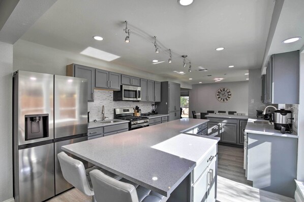 Enjoy cooking in this well-equipped kitchen with a refrigerator, microwave, oven, and sink.