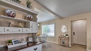 A kitchen with white cabinetry, a wooden countertop, and decorative plates on shelves. - Home w/ Fenced Yard by 5 Mighty Nat'l Parks (Circleville)