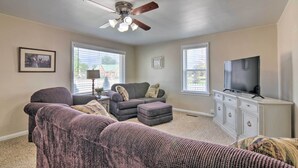 A living room with a ceiling fan, two couches, a television, and a cabinet. - Home w/ Fenced Yard by 5 Mighty Nat'l Parks (Circleville)