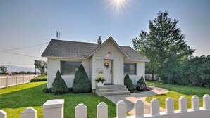 A single-story house with a front porch, a small garden with two potted plants, and a white picket fence. - Home w/ Fenced Yard by 5 Mighty Nat'l Parks (Circleville)