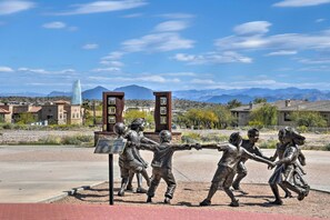 A sculpture of children playing in a park with a mountainous backdrop. - Cozy Fountain Hills Condo w/ Mountain Views! (Fountain Hills)