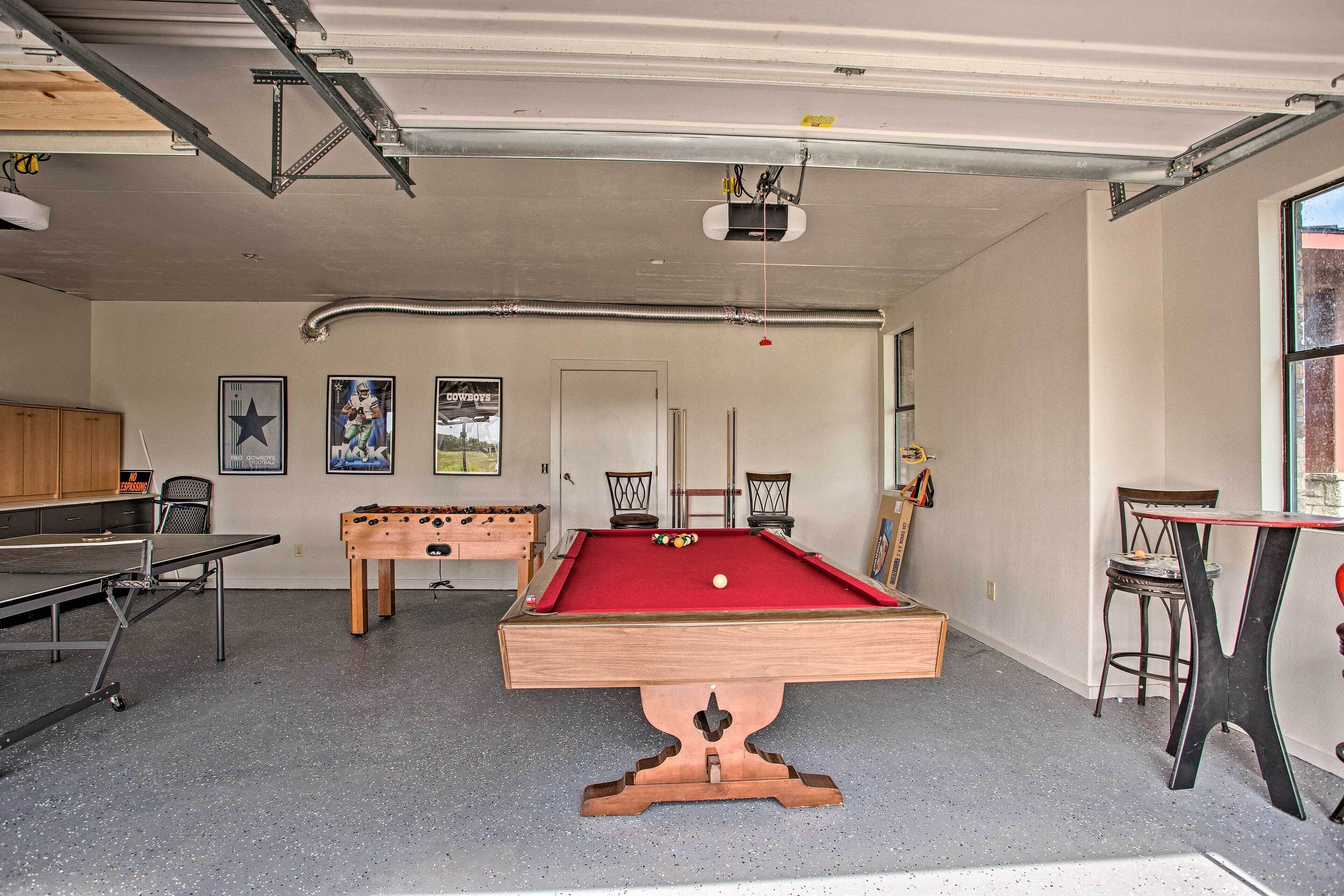 A recreational room with a pool table, foosball table, and a billiards table.