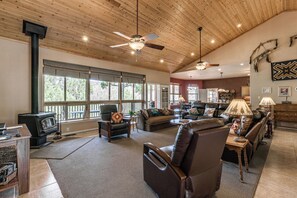 A spacious living room with a fireplace, leather furniture, and large windows. - 19 Mi to Ski Apache! Cozy Ruidoso Digs Near Dtwn (Ruidoso)