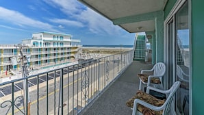 A balcony with a view of a beach and a hotel building. - Condo w/ Pool Access on Wildwood Crest Beach! (Wildwood Crest)