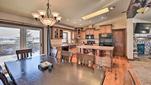 A spacious kitchen with wooden cabinets, a central island, and a dining area with a large table and chairs. - 2 Mi to Hot Springs: Nathrop Gem w/ Fire Pit (Nathrop)