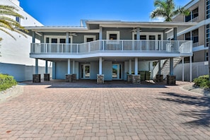 Stunning multi-story building with a central entrance and second-floor balcony.