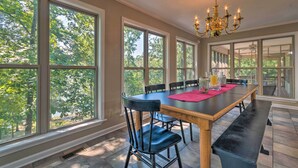A dining area with a large table, chairs, and a chandelier. - Home on Lake Catherine w/ Dock 9 Mi to Hot Springs (Hot Springs)