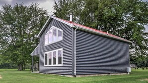 A log cabin with a gabled roof, a front porch, and a chimney. - Cozy Haven of Rest Home w/ Amish Country Views! (Shipshewana)