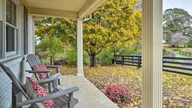 A porch with two Adirondack chairs and a concrete floor. - Peaceful Bluegrass Getaway on 10-acre Farm! (Harrodsburg)