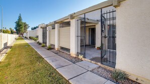 A residential building with a covered patio, a well-maintained lawn, and a gated entrance. - 4 Mi to Mill Ave: Family Retreat w/ Patio in Tempe (Tempe)
