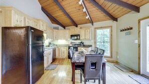 A kitchen with wooden cabinets, a stainless steel refrigerator, a dining table with chairs, and a wooden ceiling. - 2 Decks, Mountain View: Beech Mountain Cabin! (Banner Elk)