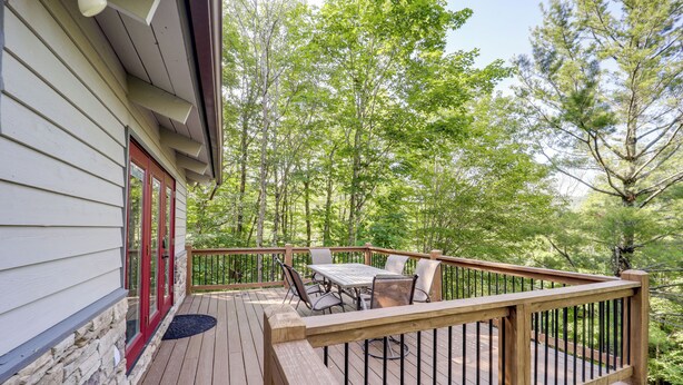 A wooden deck with a table and chairs, surrounded by trees. - 2 Decks, Mountain View: Beech Mountain Cabin! (Banner Elk)