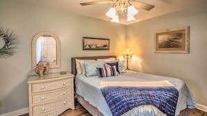 A bedroom with a bed, dresser, and two wall-mounted lamps. - Myrtle Beach Ocean-view Condo: Walk to Beach! (Myrtle Beach)