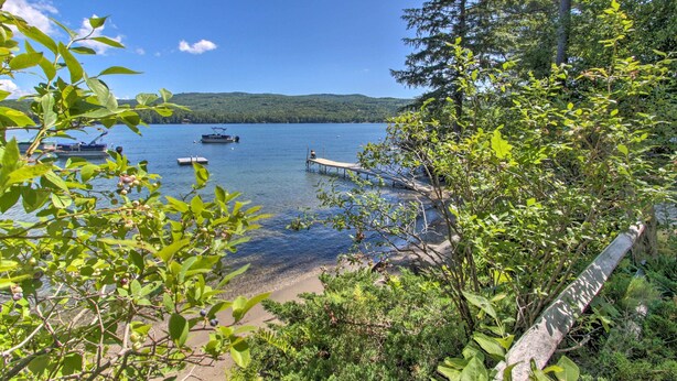 A lakeside view with boats, a dock, and surrounding greenery. - Updated Bristol Lakehouse w/ Kayaks & Beach Access (Bristol)