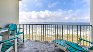 A balcony with a view of the beach and ocean. - Ocean Views & Pool Access: Orange Beach Condo! (Orange Beach)