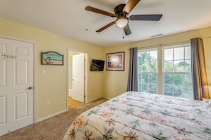 A bedroom with a bed, a ceiling fan, a window with curtains, a door labeled 'Owner's Closet,' and a wall-mounted TV. - Pool Access & Deck: Bethany Beach Gem (Ocean View)