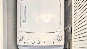 A compact, white front-loading washer and dryer unit with a control panel featuring multiple settings.