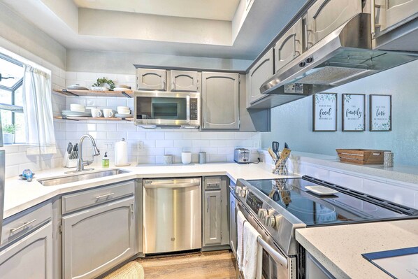 A modern kitchen with stainless steel appliances, white cabinetry, and a built-in oven. - Golf Course Views & Pool Access: Glendale Condo! (Glendale)