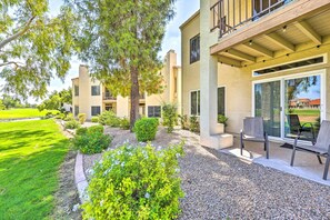 A modern building with a covered patio area, outdoor seating, and a well-maintained garden. - Golf Course Views & Pool Access: Glendale Condo! (Glendale)