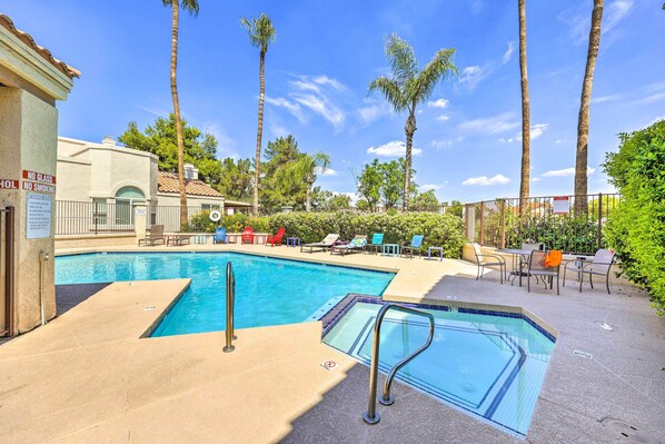 A pool area with lounge chairs and a no smoking sign.