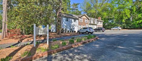 A residential street with townhouses, a gravel driveway, and a sign for Market Square.