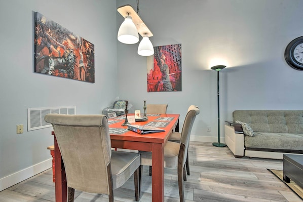 A dining area with a wooden table, chairs, and artwork on the walls. - Near Mt Airy Casino: Mount Pocono Condo w/ Balcony (Mount Pocono)