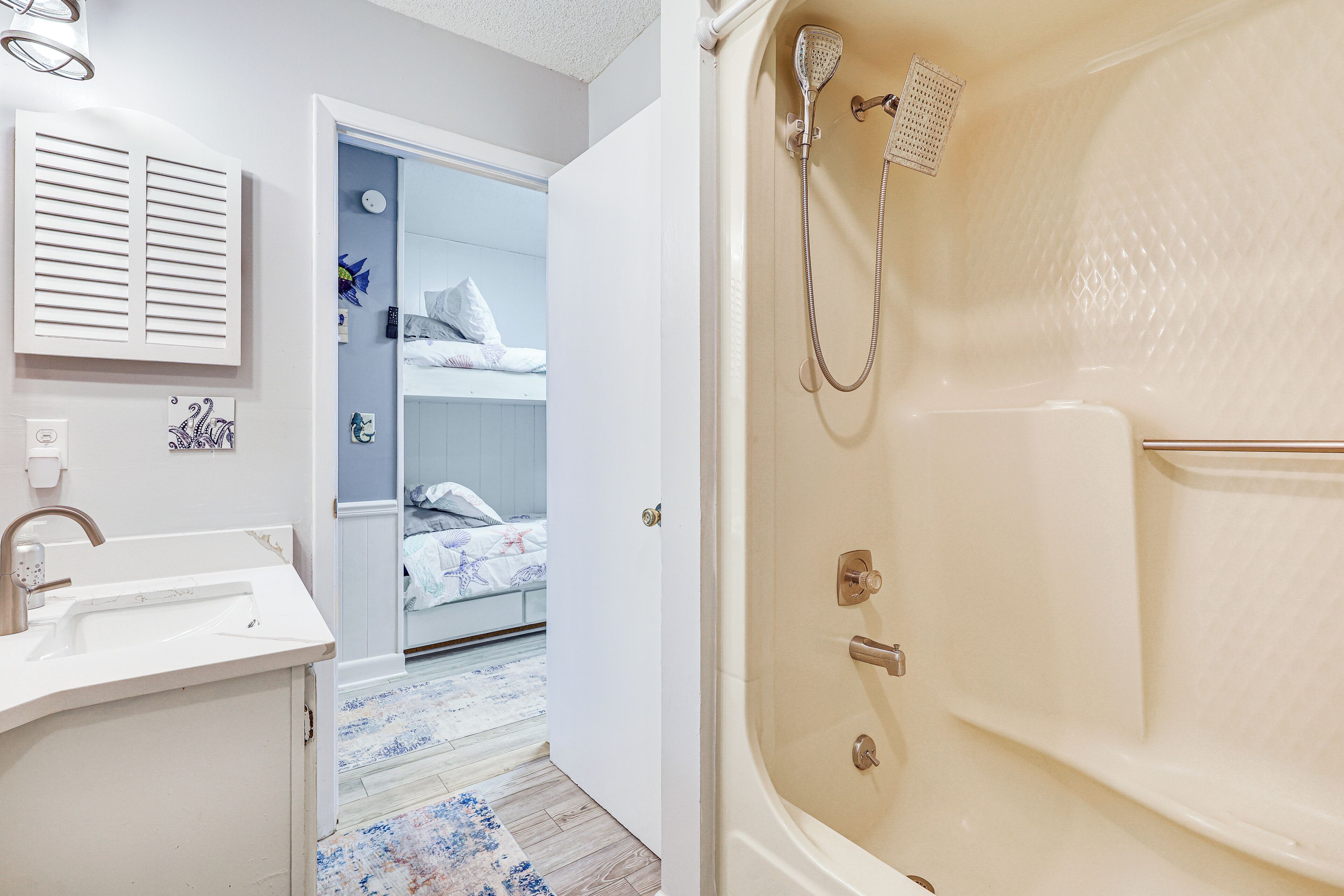 A modern bathroom with a bathtub, a sink, and a shower.