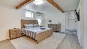 A bedroom with a wooden bed, a nightstand, a dresser, and a window. - Pool, Game Room, Hot Tub: Lake Havasu City Oasis! (Lake Havasu City)