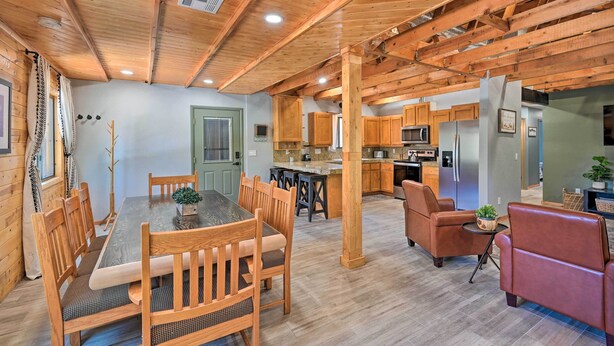 A spacious kitchen with wooden cabinets, a central island, and modern appliances. - Cabin in Tonto National Forest: Deck & Views! (Pine)