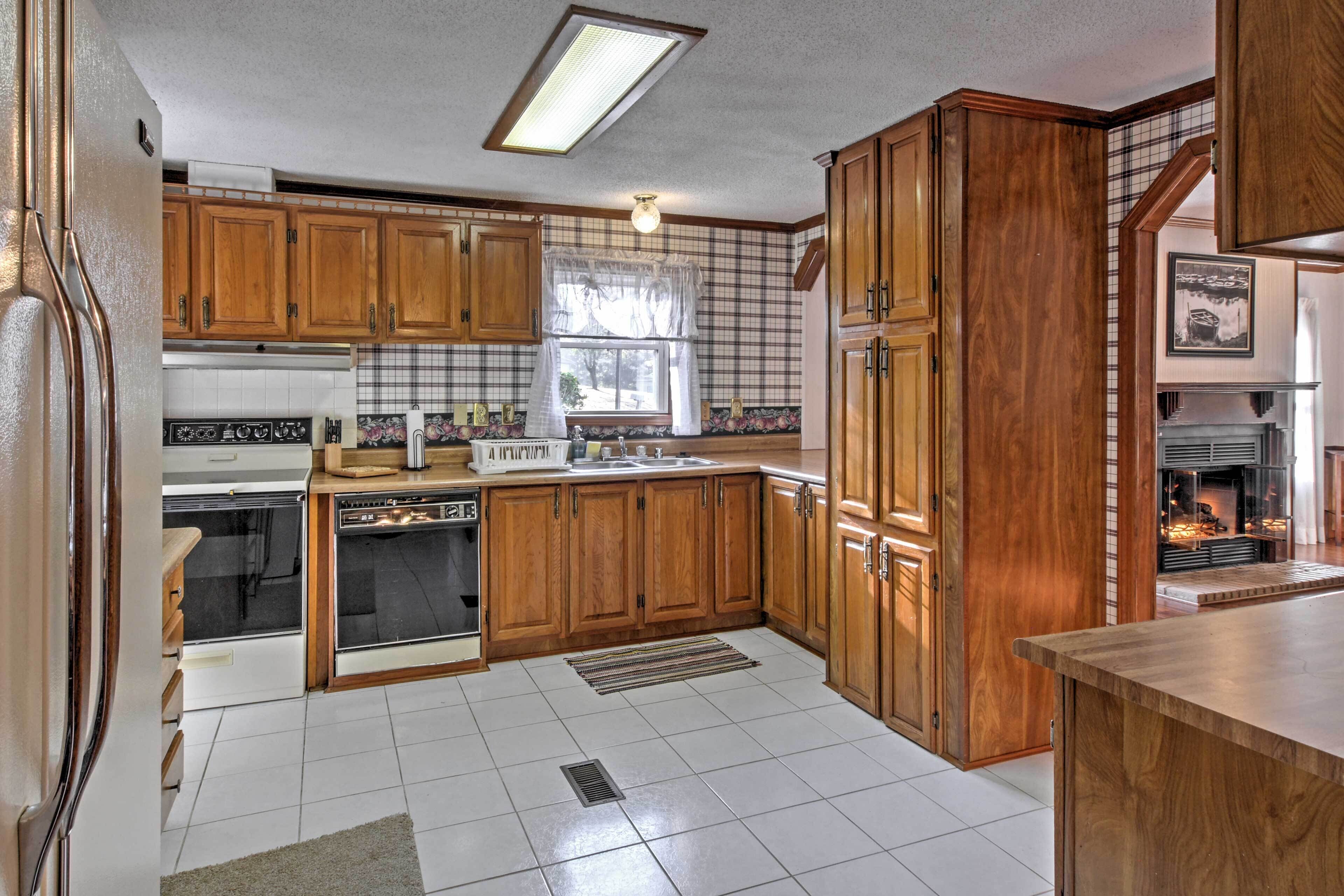 A kitchen with wooden cabinets, a stove, and a sink.