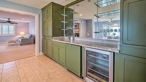 A kitchen with green cabinets, a glass shelf, and a built-in oven. - Waterfront Hampstead Home: Dock & Waterway Access! (Hampstead)