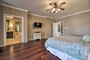 A bedroom with a large bed, a ceiling fan, and a TV on the wall. - Waterfront Lake Conroe Getaway w/ Multiple Decks! (Montgomery)