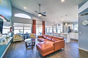 A spacious living area with a sectional sofa, a glass coffee table, and a ceiling fan. - Private Patio, Gas Grill: Stylish Phoenix Home! (Phoenix)