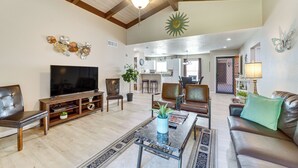 A spacious living room with a large flat-screen TV, leather sofas, a coffee table, and a dining area in the background. - Mtn-view Condo w/ Hot Tub Access in Sedona! (Sedona)