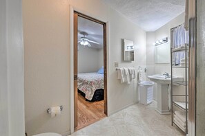 A small, clean bathroom with a toilet, sink, and shower.