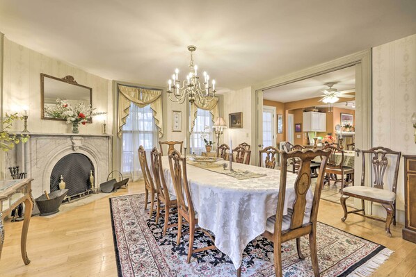 A dining room with a large table, chairs, a chandelier, and a fireplace. - Elegant Norwich House w/ Billiards Room & Ballroom (Norwich)