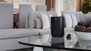 A modern living room with a sofa, cushions, a glass coffee table, a black speaker, and a remote control. - KARAT Villa Uchova - Cho Pancho (El Frontón)