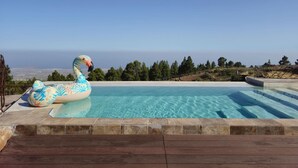 A swimming pool with a wooden deck and a view of the ocean. - KARAT Villa Uchova - Cho Pancho (El Frontón)