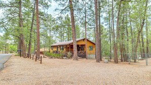 A lodge with a wooden exterior, surrounded by tall pine trees, and a gravel driveway leading to the entrance. - 10 Mi to Show Low: Pinetop-lakeside Family Cabin! (Lakeside)
