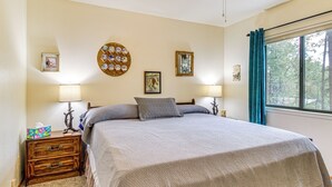 A bedroom with a large bed, two bedside tables, a dresser, and a window with curtains. - 10 Mi to Show Low: Pinetop-lakeside Family Cabin! (Lakeside)