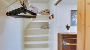 A staircase with a wooden handrail and a hanging coat rack. - Tucson Home ~ 8 Mi to Saguaro National Park (Tucson)
