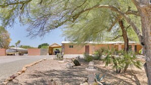 A desert-style building with a gravel driveway, a cactus garden, and a large tree providing shade. - Tucson Home ~ 8 Mi to Saguaro National Park (Tucson)