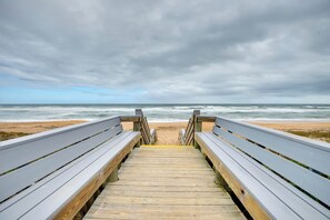 A wooden boardwalk leading to a beach with a cloudy sky. - Bright Ormond Beach Home ~ 14 Mi to Daytona! (Ormond Beach)