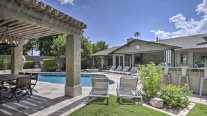 A backyard with a pool, outdoor seating, and a pergola. - Outdoor Kitchen: Desert Dream Home in Scottsdale! (Scottsdale)
